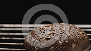 Baking rye bread with cereals and seeds in a grilled oven. Stock footage. Close up of round shaped loaf of tasty and