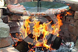 Baking sausages at the campfire photo