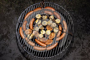Baking sausages, sheeps cheese and corn on a metal grate fired with birch wood.