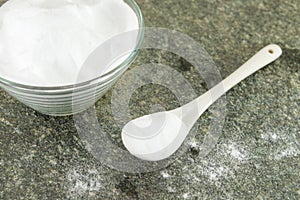 Baking soda in a bowl and spoon of soda