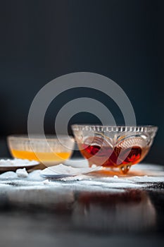Baking soda face mask in a glass bowl on wooden surface along with baking soda powder and honey photo