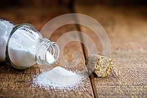 Baking soda glass with open lid. Rustic wood background