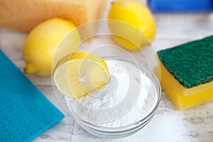 Baking soda, lemon, sponge and dishtowel