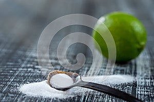 Baking soda - sodium bicarbonate and lemon. Natural, powder on a grey wooden background