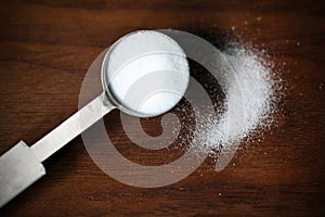 Baking soda or sodium bicarbonate in a tea spoon and dusted photo