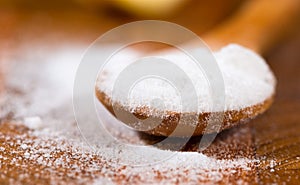 Baking soda (sodium bicarbonate) in a wooden spoon