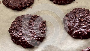 Baking sweet chocolate oat bisquits in the oven, homemade food recipe, slow motion