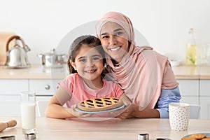 Baking Together. Portrait Of Happy Arabic Mother And Daughter Holding Homemade Pie