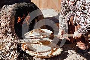 Baking traditional bread in a natural clay oven.