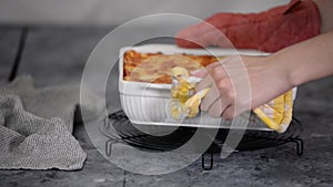 Baking tray with tasty lasagna on cooling rack.