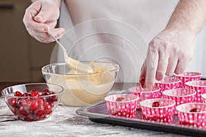 Baking Trays With Raw Muffin Dough In Paper Cases