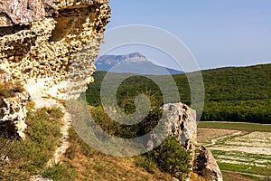 Bakla is ancient cave town in Crimea. Scenic sunny day landscape of Bakla under blue sky