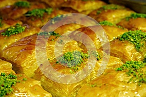 Baklava or pakhlava with green pistachio powder, close-up, selective focus