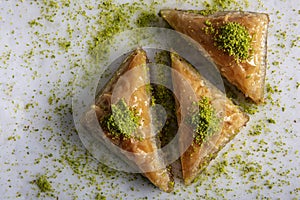 Baklava shop. Turkish pistachio and yufka dessert, a plate of pistachio baklava on a marble tray