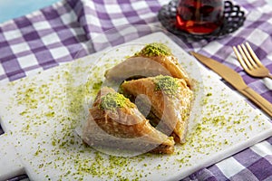 Baklava shop. Turkish pistachio and yufka dessert, a plate of pistachio baklava on a marble tray