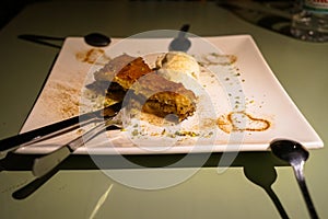 Baklava, traditional sweet dessert pastry filled with chopped nuts and sweetened with syrup serving with ice cream decorated
