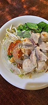 Bakso, indonesian meatball style served with beef broth soup and noodle springkled with fried onion and spring onion coupled with