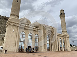 Baku, Azerbaijan, September, 11, 2019. People walking near shiite mosque Bibi-Eibat in autumn in cloudy day. Baku, Azerbaijan