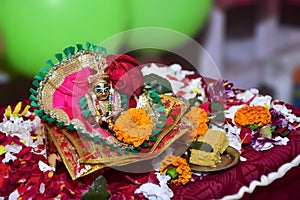 Bal Krishna Laddu Gopal, an Hindu God, brass statue with beautiful pink cloths and jewelry. Celebrating Krishna Janmashtami