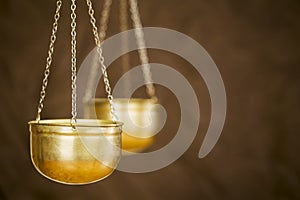 Balance concept, gold weighing scales on brown background photo