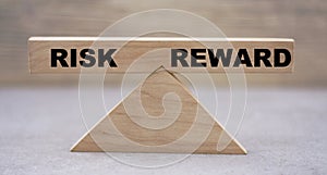 Balance concept on wooden RISK on a REWARD wooden background