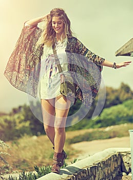 Balance is essential to a happy life. a free spirited young woman enjoying the sunshine outside.