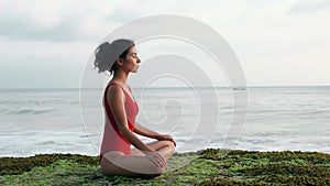 Balance and harmony with nature. Concept of welless, yoga poses. Brunette portrait doing breathing exercises while the