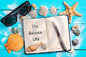 The balance life text in note book with Few Marine Items photo