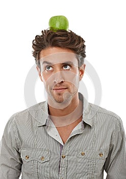 Balance, man and apple on head, thinking of food and healthy diet isolated on a white background in studio. Idea, person