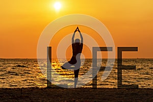 Balance meditation yoga spirit life mind woman peace vitality, silhouette outdoors on the sunset, relax vital abstract. Standing a photo