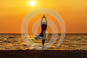 Balance meditation yoga spirit lifestyle mind woman peace vitality, silhouette outdoors on the Sea sunrise, photo