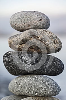 Balance pebble stone in the stoned beach at sunset. Stack of zen stones in harmony and balance with sea view. minimalist view of