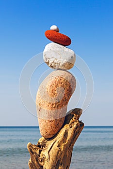 Balance pebbles on the clear blue sky background. Concept of harmony, balance and meditation