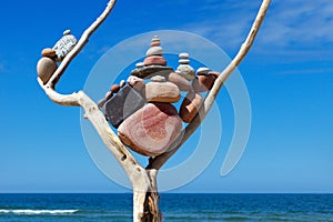 Balance and poise stones. Rock zen on the background of blue sky and sea