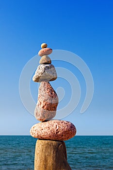 Balance and poise stones. Rock zen on the background of blue sky and sea