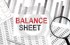 BALANCE SHEET text on paper with calculator,magnifier ,pen on the graph background