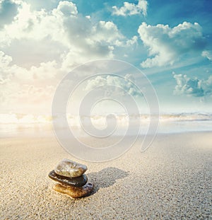 Balance stone on the beach in sunrise, vintage tone