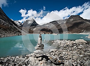 Balance: Stone stack and Sacred Lake near Gokyo