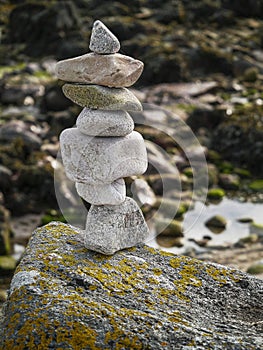 Balance stones on a rock. Blurred background. Concept hard work, goal achievement, insistence, tenacity