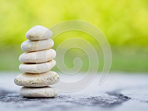 Balance Stones stacked to pyramid in the soft green background