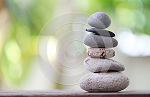 Balance Stones stacked to pyramid in the soft green background. photo