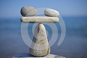 Balance of stones. To weight pros and cons. Balancing stones on the top of boulder. Close up.