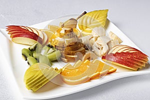 Balanced exotic fruits salad on plate, proper nutrition