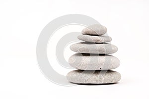 Balanced grey stones over white background