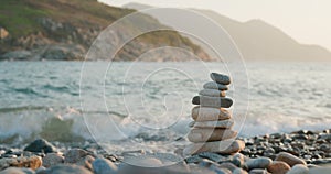 Balanced pebble pyramid on the beach