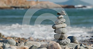 Balanced pebble pyramid on the beach