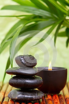 Balanced pebbles and aromatherapy candle