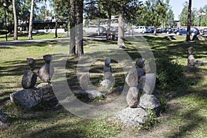 Balanced pyramids from pebbles standing in urban park at the entrance to the Korela Fort or Kexholm Fortress. Priozersk, Russia