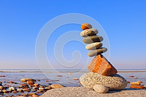 Balanced Rock Zen on the background of the sea. The concept of fall risk and unstable equilibrium