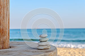 Balanced several Zen stones on blurred beautiful the beach background